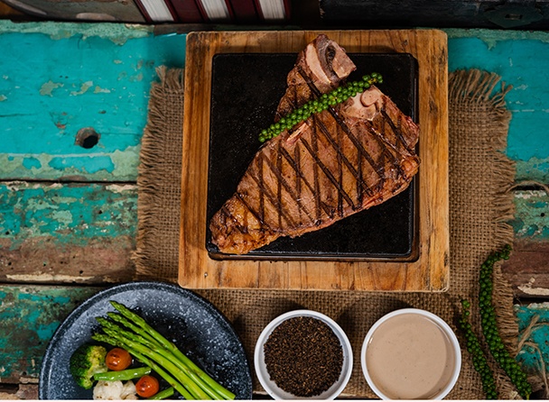 T-bone Steak in Kampot Pepper Sauce with French Fries and Side Salad